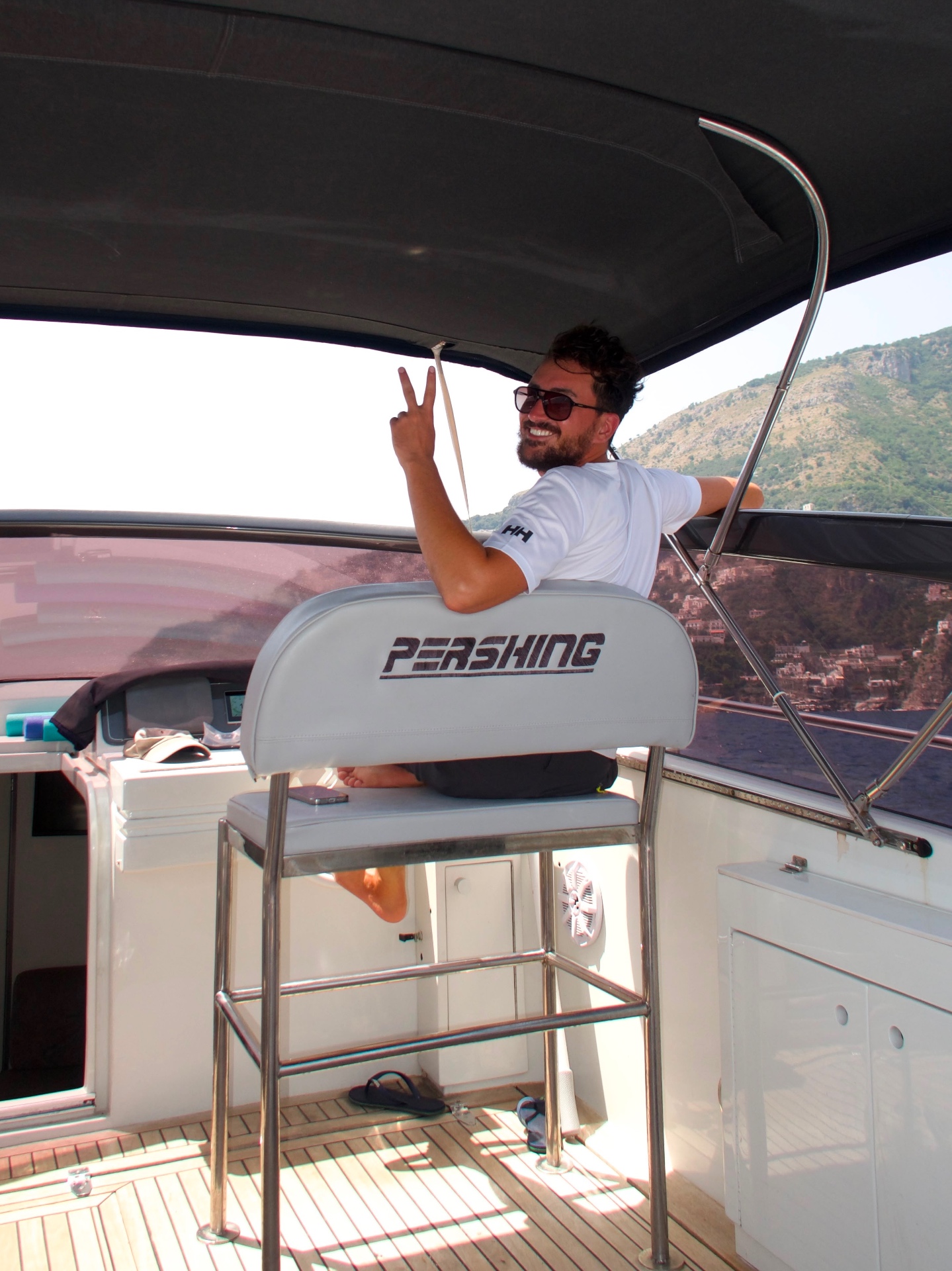 Giovanni at the helm of the Pershing in front of Positano